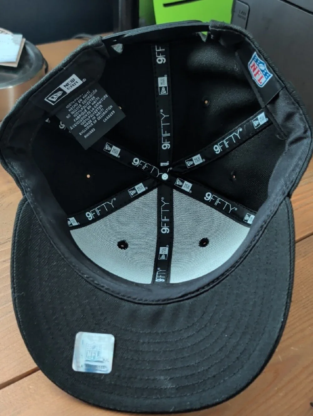 New Era Black Snapback Hat with Gray-Outlined Lion Patch